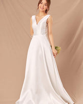 Silk sleeveless V-neck gown with lace-up side detail and full-length flowing A-line skirt